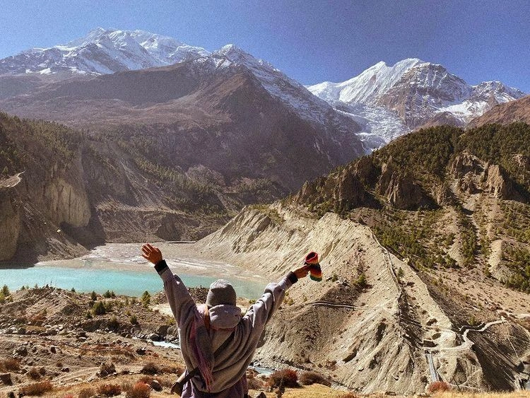 A female guide posing for a photo in Manang