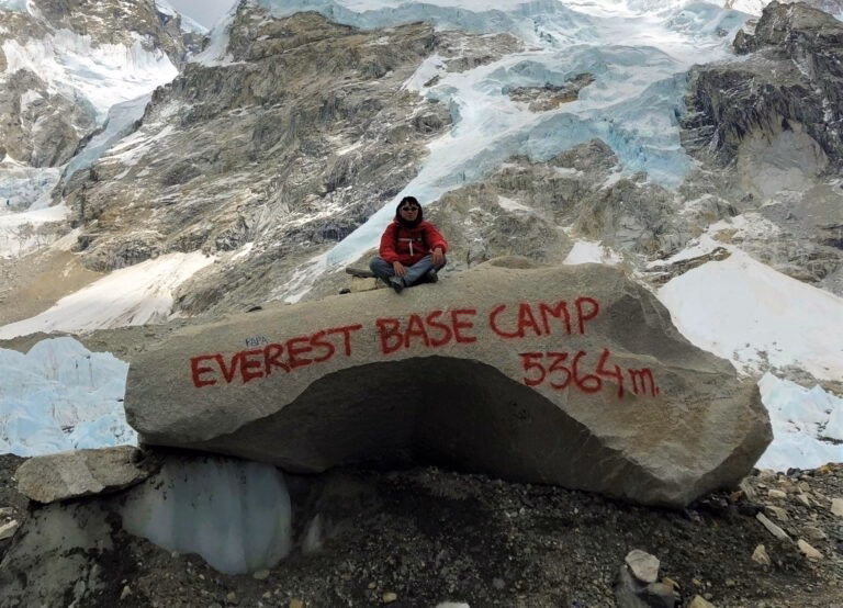A girl sitting on a stone in Everest Base Camp