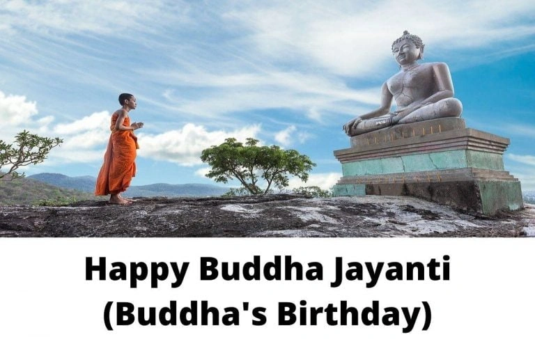 A monk praying in front of a buddha statue