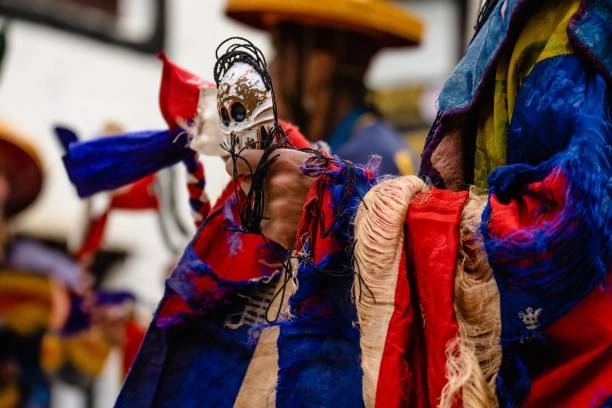 ritual dancer holding a skull idol at the Tiji Festival