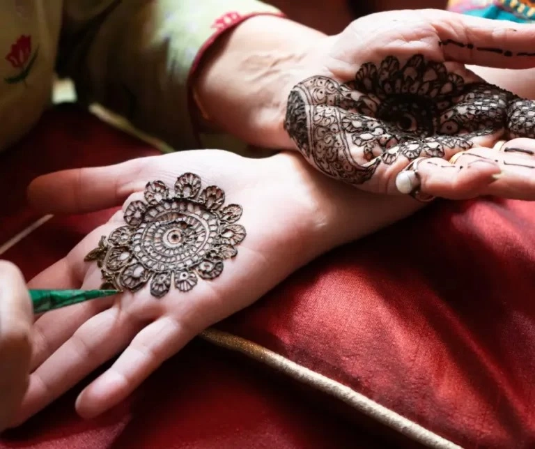 Hand decoration with Mehendi in teej