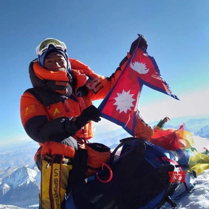 Kami Rita Sherpa holds the Nepalese flag on the mountain..jpg