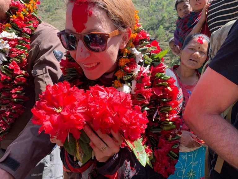 Michelle being welcomed by flower garlands