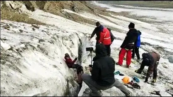 Police recovering the body of an Indian mountaineer