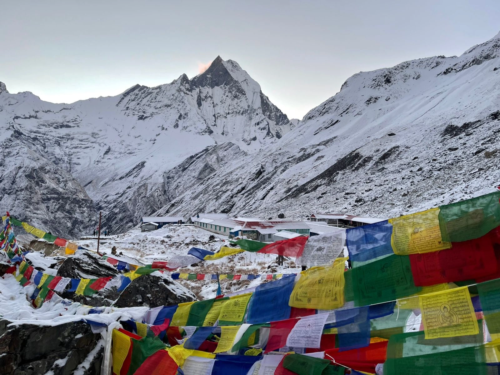 Prayer flags and snowy view of ABC