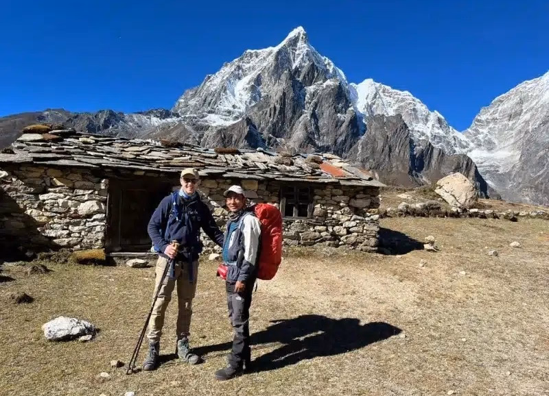 Trekkers taking a break in stonehouse near Dingboche in Everest