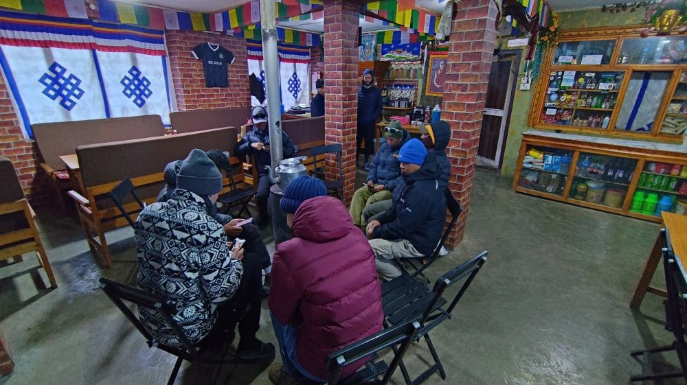 Trekkers warming themselves near Firestove